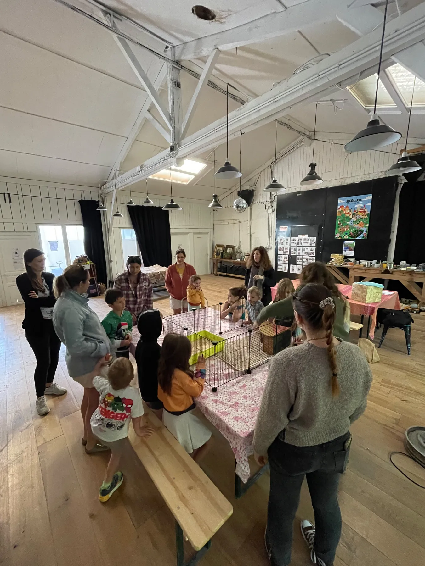 Children and adults gathering for a closer look during an activity in our community room.