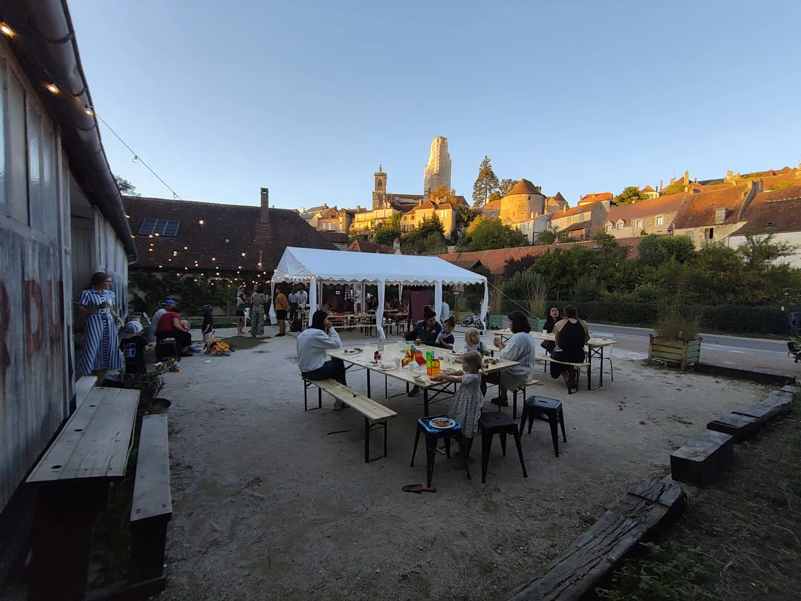 Shared tables, evening light and the rooftops of Semur-en-Auxois behind us.