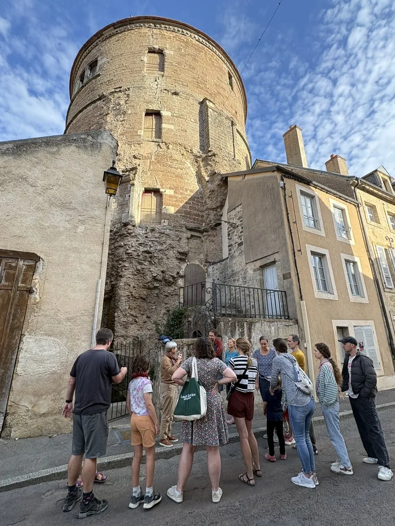 Stopping beneath one of the medieval towers while exploring the town together.