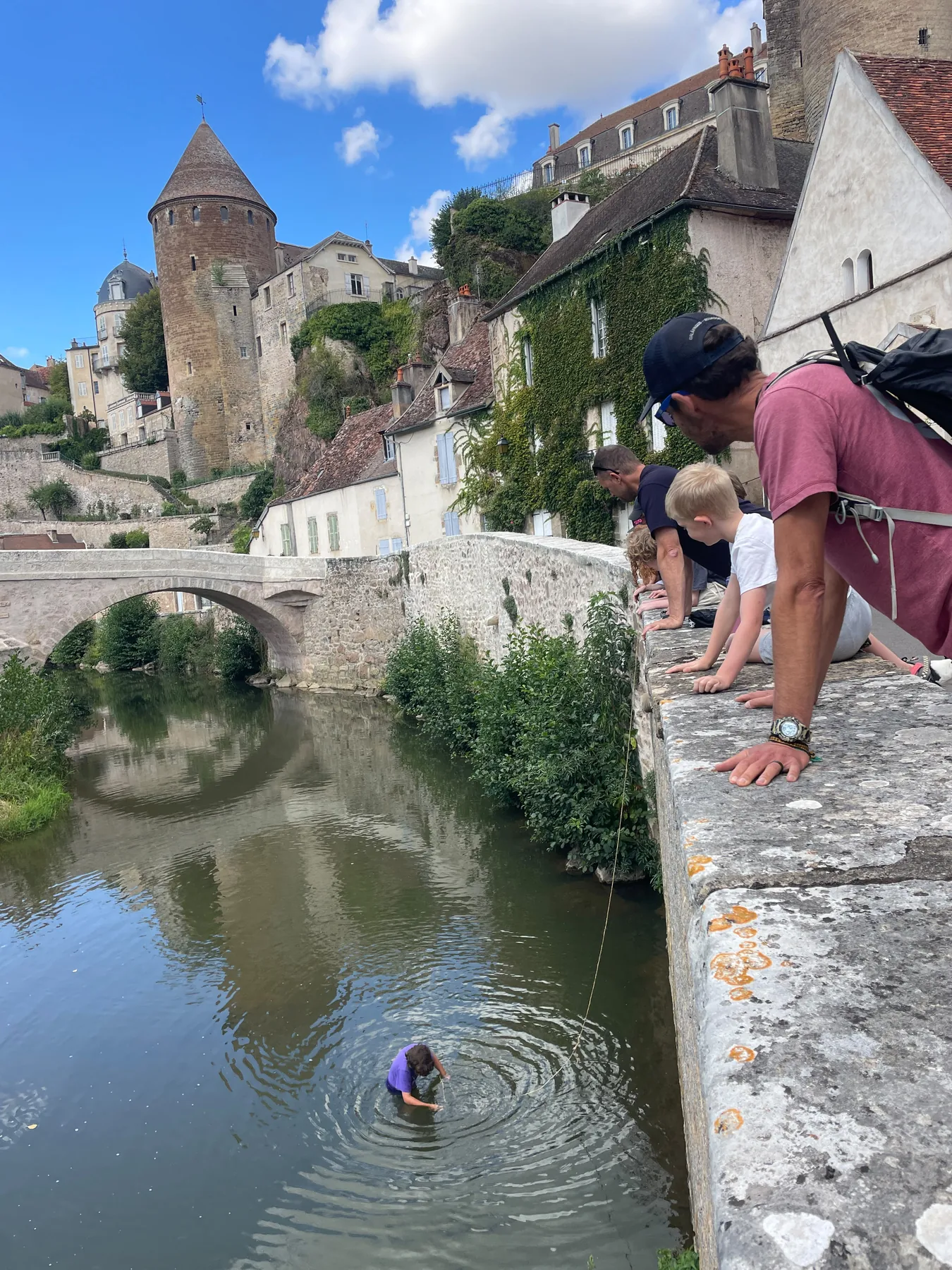 A stop on the bridge, with the river and medieval towers below and above us.