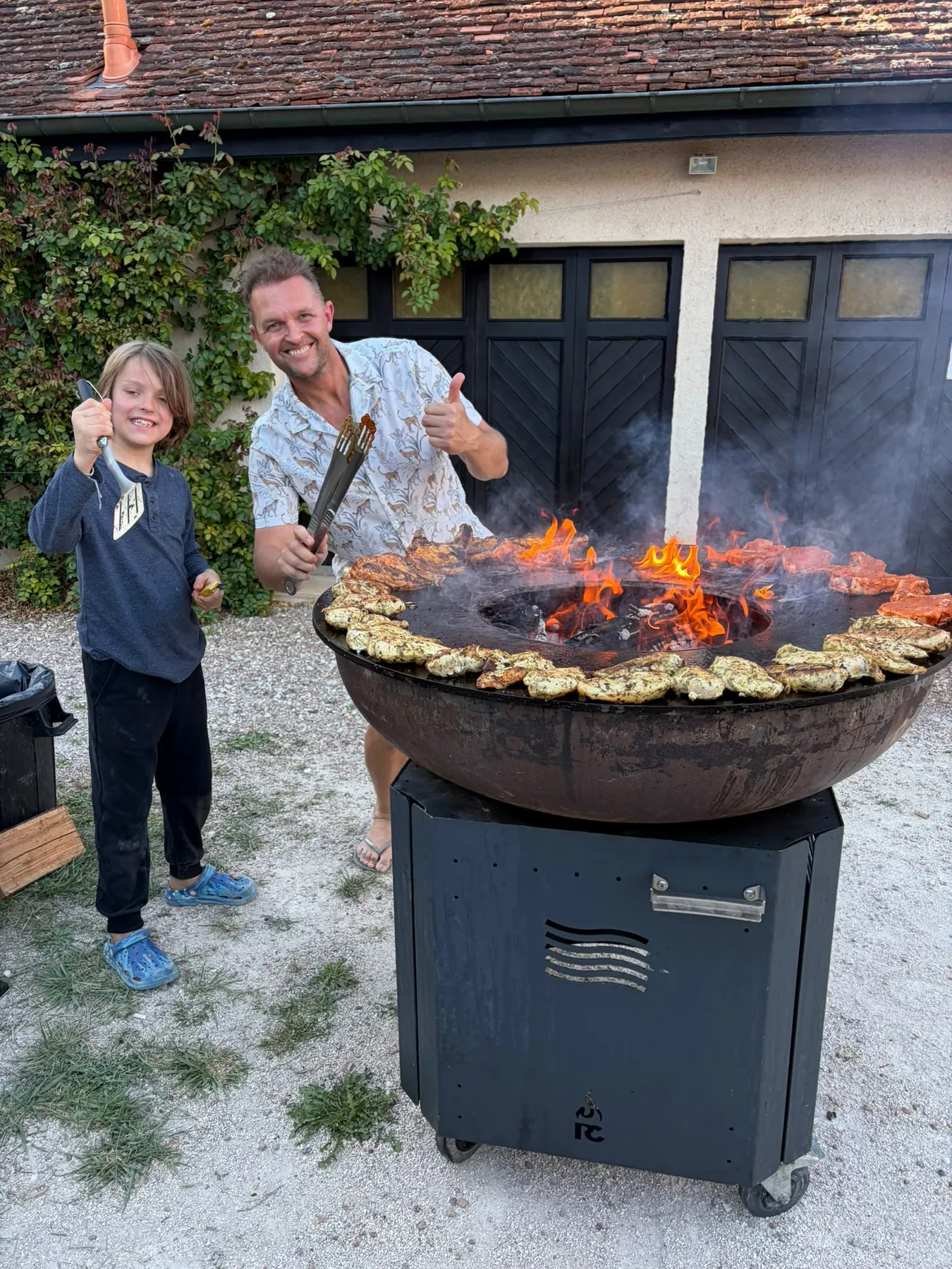 Cooking for the village around the big courtyard barbecue.